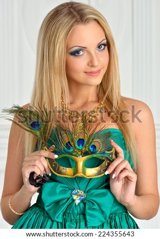 Beautiful woman in evening gown with carnival mask.