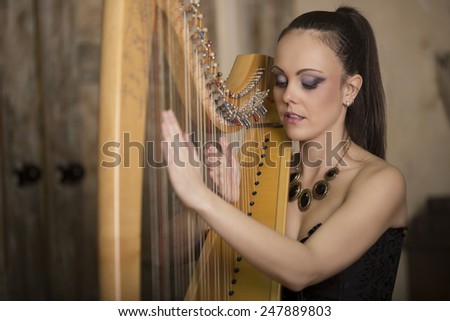 A young woman enjoying music while running on the instrument harp