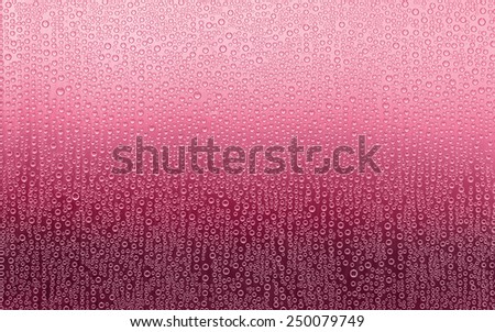 Red Water Droplets. Water condensation forms a random pattern of circular water droplets of varying sizes. Background fades from pink to dark red.