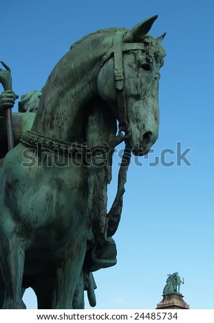A bronze horse in Budapest green after rain