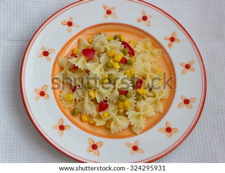 farfalle with vegetable served on painted plate