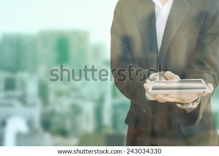 Young man with business suit with a tablet in the hand