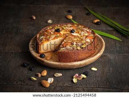 Similar – Foto Bild Süßer Kuchen mit Nüssen und Blumen auf Ständer auf Tisch