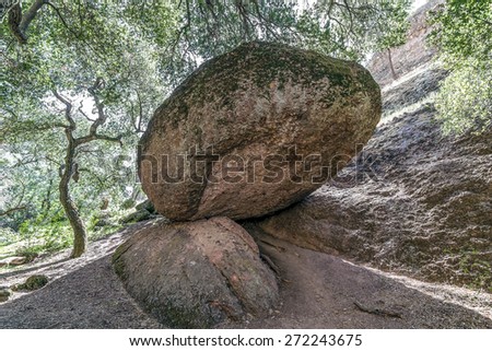 Huge massive balanced boulder is kept from rolling away at Pinnacles National Park in Monterey County, California, near the Salinas Valley, on the California Central Coast.