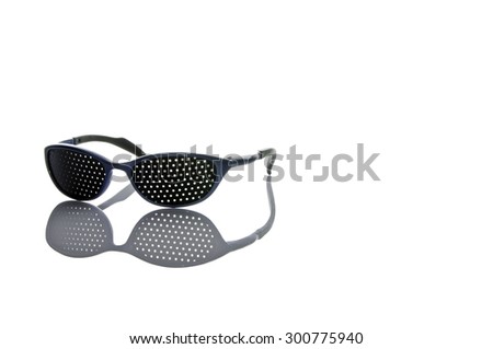 Pair of medical pinhole glasses with reflections on white background. The frame is blue and the plastic glasses are black. Photo taken in July 2015.