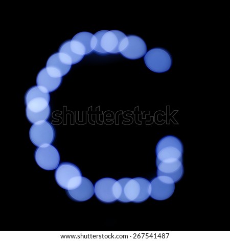 letter of Christmas lights on a dark background, the letter G, 