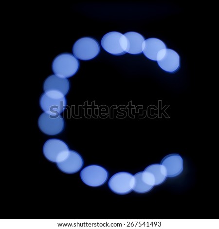 letter of Christmas lights on a dark background, the letter C, \