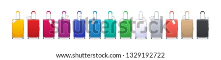 Colorful set of modern plastic suitcases with wheels, retractable handle and luggage tag label on suitcase with country code and barcode. Polycarbonate suitcases isolated on white.