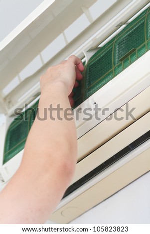 Placing back clean filter into air-conditioner