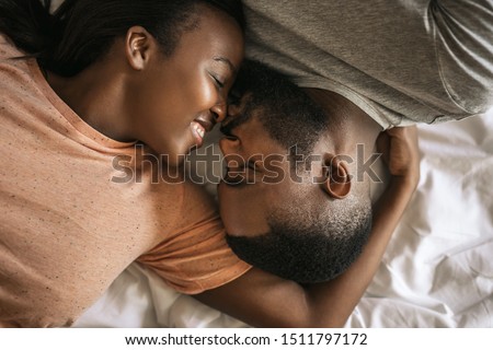 Similar – Image, Stock Photo Couple lying on bed and hugging in morning in nightwear