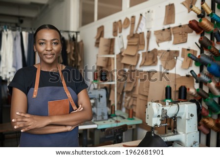 Young African female leather worker standing in her studio 商業照片 © 