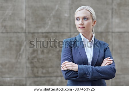 A young businesswoman with her arms folded