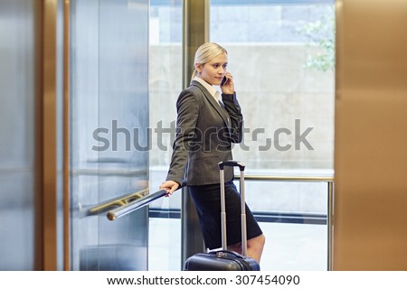 Businesswoman talking on the phone in elevator