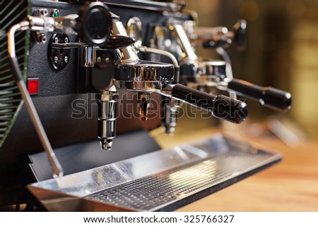 Well-kept espresso machine up close with the chrome looking shiny and the whole piece of equipment looking very clean
