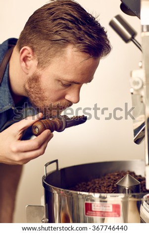 Business owner smelling freshly roasted coffee beans for aromati Zdjęcia stock © 