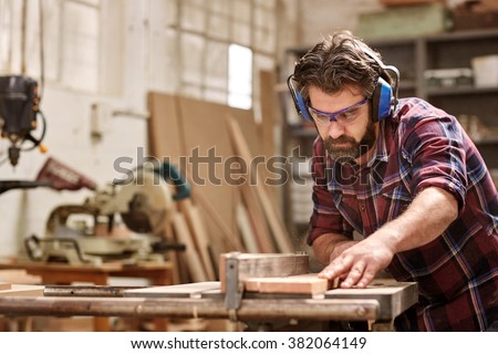 Similar – Image, Stock Photo Male woodworker cutting wood in workshop