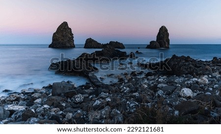 Cyclops Islands, Faraglioni of Aci Trezza. Small Sicilian archipelago. Large islands and rocks of volcanic origin. Etna National Park, marine protected area. Big rocks at sunset by the sea. ストックフォト © 