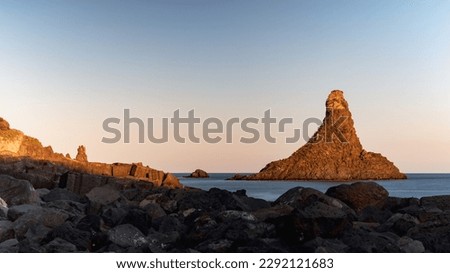 Cyclops Islands, Faraglioni of Aci Trezza. Small Sicilian archipelago. Large islands and rocks of volcanic origin. Etna National Park, marine protected area. Big rocks at sunset by the sea. ストックフォト © 