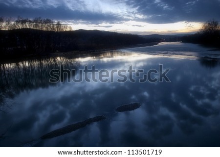 relaxing landscape with water at sunset
