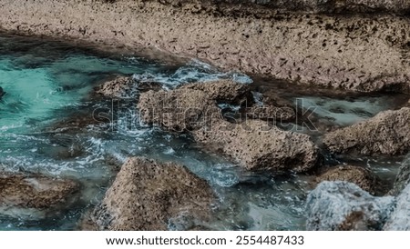 Similar – Image, Stock Photo Further wet beach in the shimmer of the sunset. Waves, clouds and people in the distance.