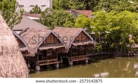 Similar – Image, Stock Photo A few wooden huts and many bushes and trees are standing around on a hilly green meadow landscape in the nature park Ammergau Alps in Upper Bavaria and a piece of bicycle path can be seen as well.