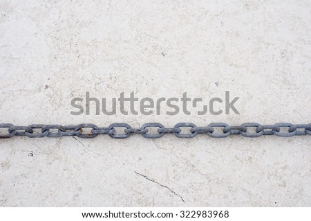 Steel chain on a clean stone background