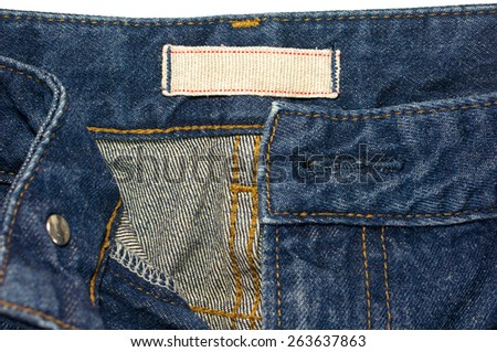 Blue jeans with blank white cloth label isolated on white background