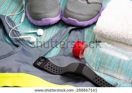 Sport clothing, heart rate monitor watch, running shoes, earphones and drinking water
