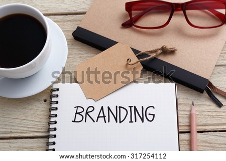 Branding concept with notebook brand tag and glasses on work desk