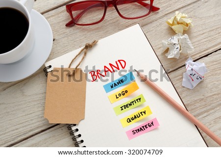 Brand marketing concept with notebook, brand tag and coffee cup on office desk