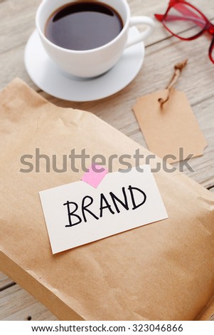 Brand marketing concept with product package, brand tag and coffee cup on wood desk