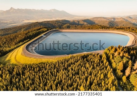 Hydroelectric power plant Cierny Vah. Sunset in Slovakia, Liptov. High Tatras scenery. Monumental peaks over water level Zdjęcia stock © 