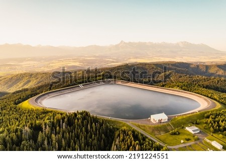 Hydroelectric power plant Cierny Vah. Sunset in Slovakia, Liptov. High Tatras scenery. Monumental peaks over water level Zdjęcia stock © 