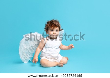 Similar – Image, Stock Photo Young baby sits up in bed with stuffed animal toys; child wearing diaper