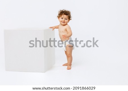 Similar – Image, Stock Photo Young toddler standing up looking at a fabric children’s book; eclectic decor with house plants