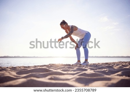 Similar – Image, Stock Photo Athletic woman resting after workout at stadium