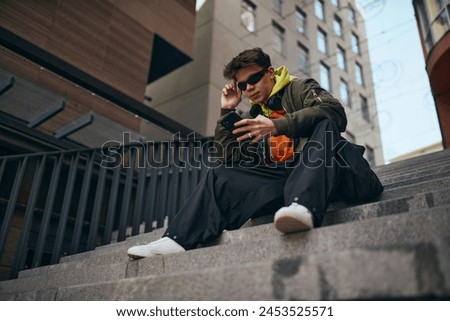 Image, Stock Photo Stylish man sitting at airport with suitcase and laptop, working, typing, browsing. Businessman traveling.