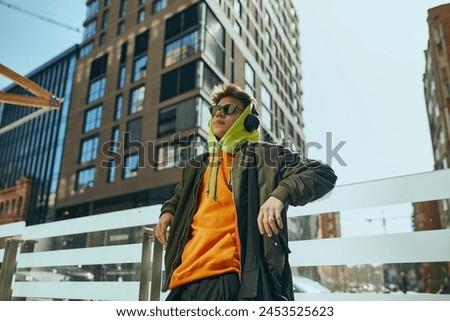 Similar – Image, Stock Photo Young hipster man at the airport or bus station waiting while calls someone with the phone, luggage, bags and suitcase. Young man long hair hipster traveler with sunglasses, copy space, sunny day