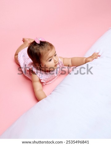 Similar – Image, Stock Photo Baby reaching for feet, dimpled baby hands, triangle print blanket and pants