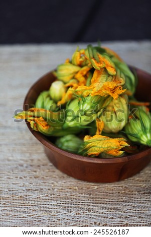 Squash blossoms in a wooden bowl