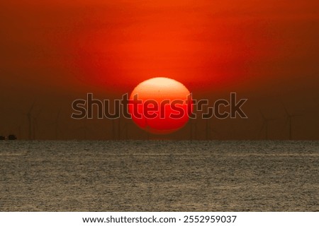 Image, Stock Photo Silhouettes of some wind mills on the top of a mountain during a super orange sunset with copy space peaceful