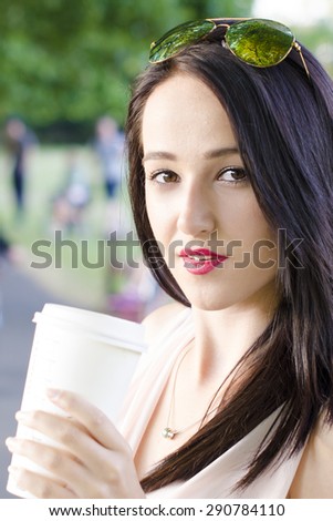 Pretty woman with coffee in a nature