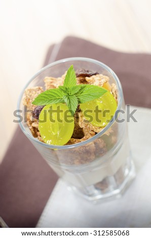 Glass of cereal product with fruit and mint
