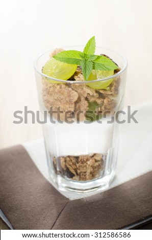 Glass of cereal product with yogurt and fruit