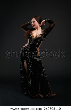 woman dancing oriental dance in a luxury chocolate suit