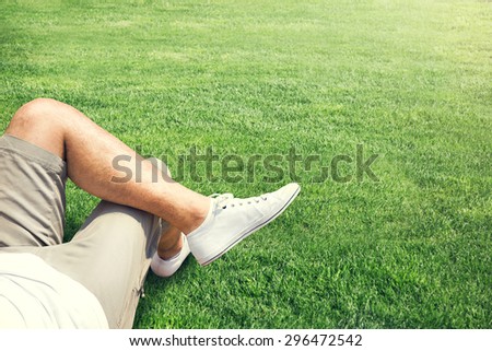Man resting outdoor on a grass field