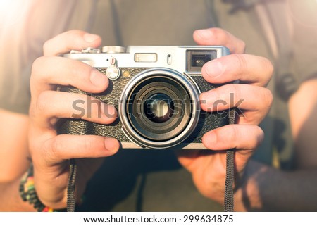 photographer holding vintage reportage camera