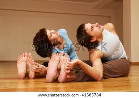 young couple doing yoga indoor