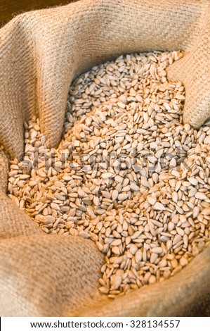 Sun-ripened sunflower seeds offered in gunnysack; Assortment of health food store