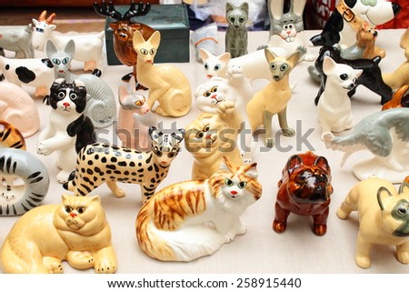 MOSCOW - MARCH 8, 2015: A free public art market on the pedestrian Arbat Street. Russians toys. Vintage porcelain figurines of animals.